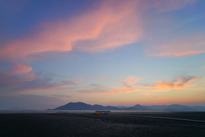 Scenic view of beach against sky during sunset