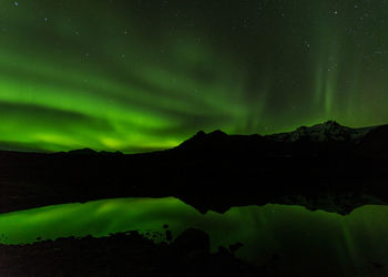 Scenic view of lake against sky at night