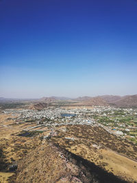 High angle view of land against clear blue sky