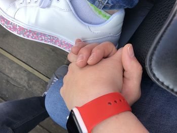 High angle view of couple hands