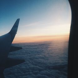 Cropped image of airplane flying over sea