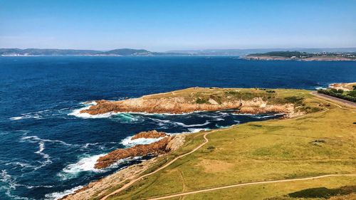 Scenic view of sea against clear blue sky