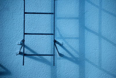 Ladder on blue wall