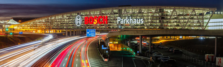 Light trails on bridge in city at night