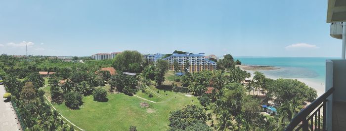 Scenic view of sea by buildings against sky