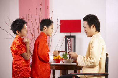 Father greeting sons during festival