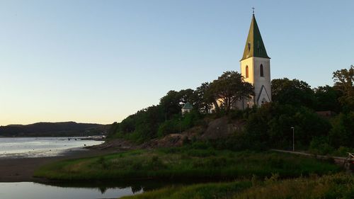 Church by building against clear sky