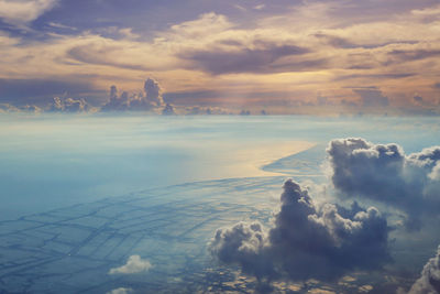 Flying above the clouds. view from the airplane,land and sky