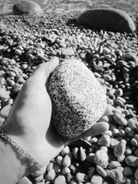 Cropped hand holding stone