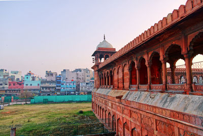 Buildings in city against clear sky