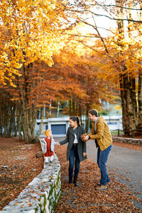 Rear view of people walking on street