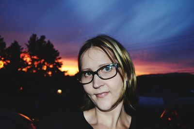 Portrait of smiling woman against sky during sunset