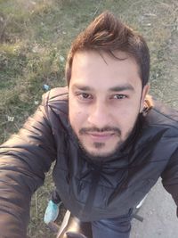 Portrait of young man standing outdoors