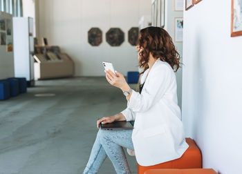 Midsection of woman using mobile phone