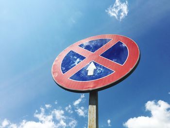 Low angle view of sign against blue sky