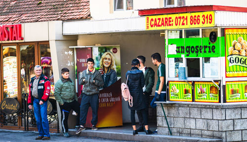 Portrait of people standing against graffiti wall