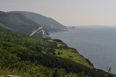 Scenic view of sea and mountains against sky