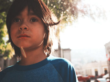 Close-up portrait of boy against sky