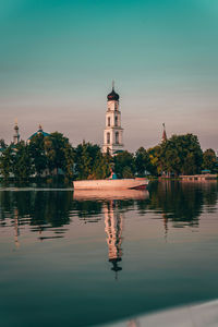 Reflections of a boat and building in lake