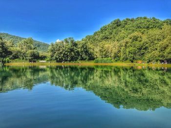 Scenic view of lake against blue sky