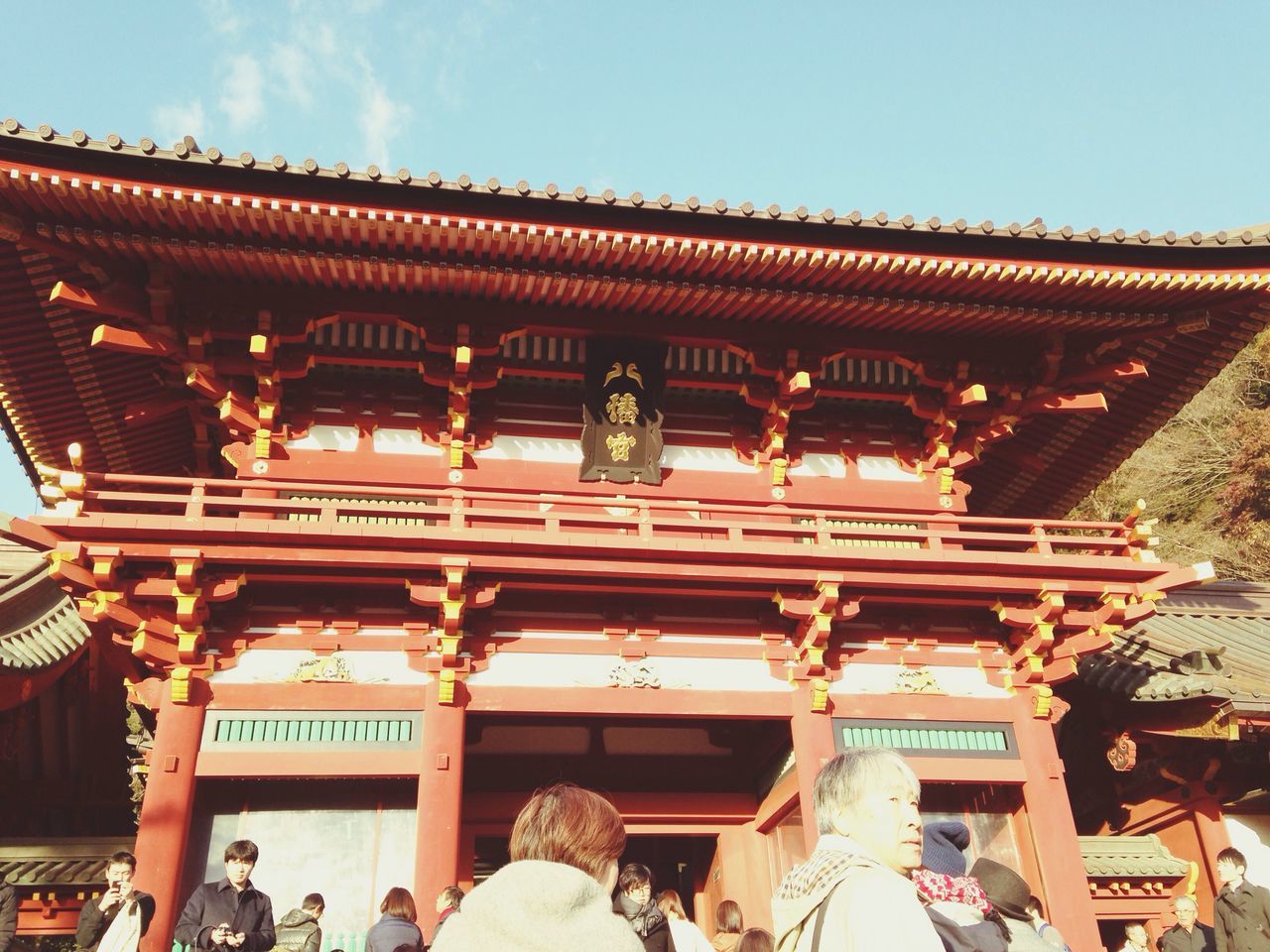 building exterior, architecture, built structure, roof, low angle view, religion, place of worship, temple - building, spirituality, facade, text, tradition, sky, culture, travel destinations, outdoors, ornate, cultures, temple