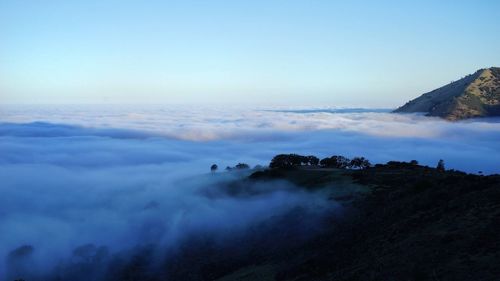 Scenic view of mountains against cloudy sky