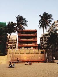 Palm trees and buildings against sky