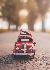 Close-up of red toy car on street