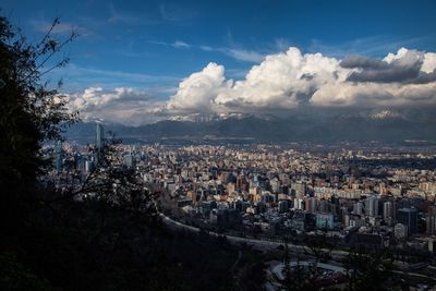 High angle view of cityscape against cloudy sky