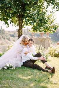 Couple kissing on tree in park