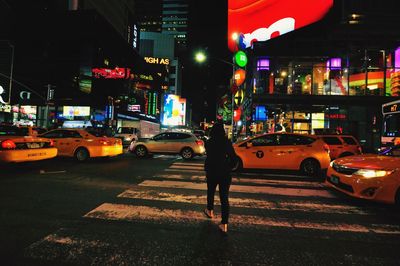 Man on city street at night