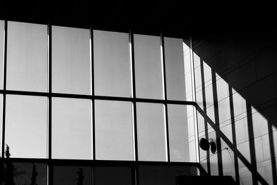 Low angle view of glass building against sky