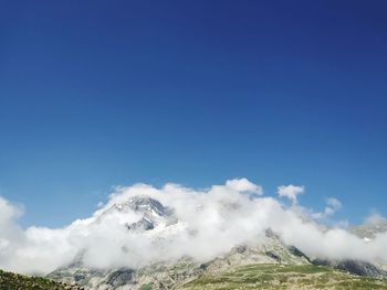 Low angle view of snowcapped mountains against sky