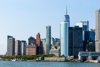 Modern buildings in city against clear sky