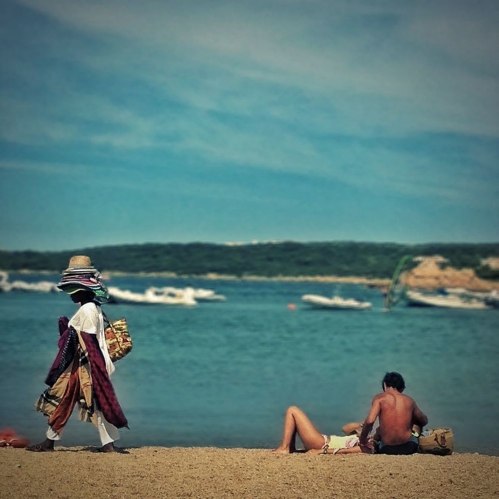 water, sea, lifestyles, sitting, leisure activity, beach, sky, relaxation, shore, vacations, rear view, tranquility, men, person, tranquil scene, scenics, sand, beauty in nature