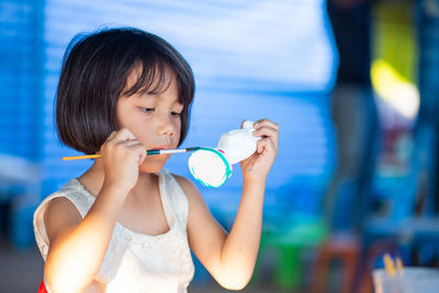 Portrait of a girl holding toy