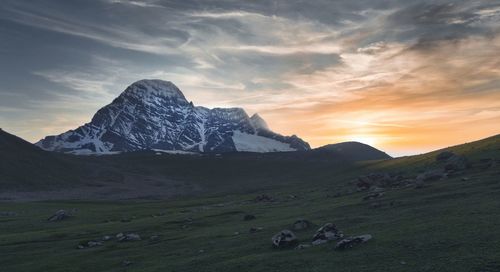 Scenic view of field against sky during sunset