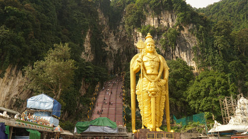 Statue of buddha against trees