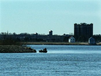 Calm river against clear sky