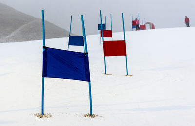 White flag on beach against sky