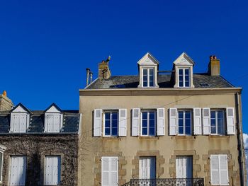 Low angle view of house against clear blue sky