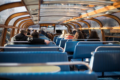 Rear view of people traveling in boat