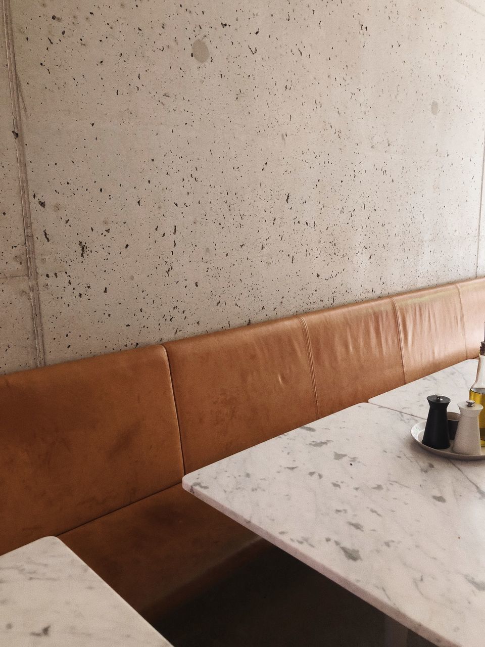 LOW ANGLE VIEW OF SOFA ON TABLE AGAINST WALL