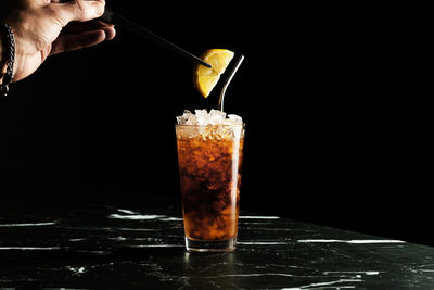 Cropped hand of woman holding drink