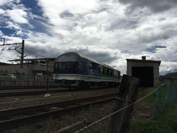 Train on railroad tracks against sky