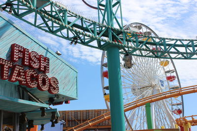 Low angle view of ferris wheel against sky