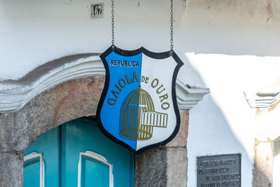 Low angle view of text on wall against building