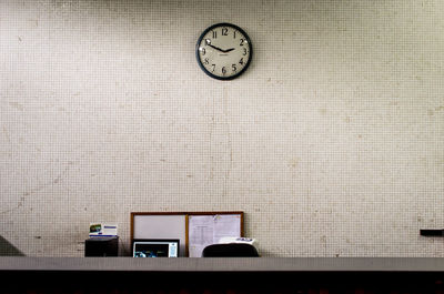 Low angle view of clock on wall