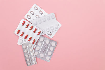 Close-up of clock on pink background