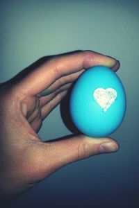 Close-up of hand holding blue ring
